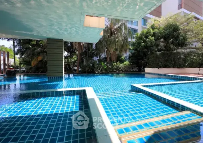 Luxurious outdoor pool area with modern design and lush greenery, perfect for relaxation and leisure.