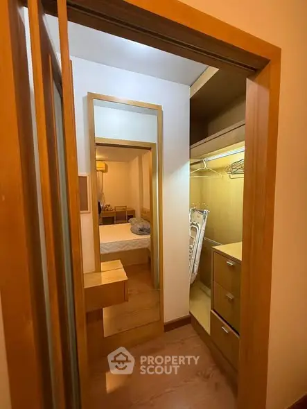 Spacious walk-in closet with wooden finish and ample storage space.