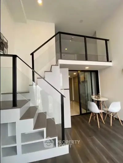 Modern duplex apartment with sleek staircase and stylish interior design