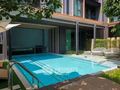 Luxurious outdoor pool area with modern design and stylish seating in a high-end residential complex.