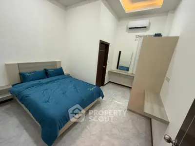 Modern bedroom with blue bedding and sleek design