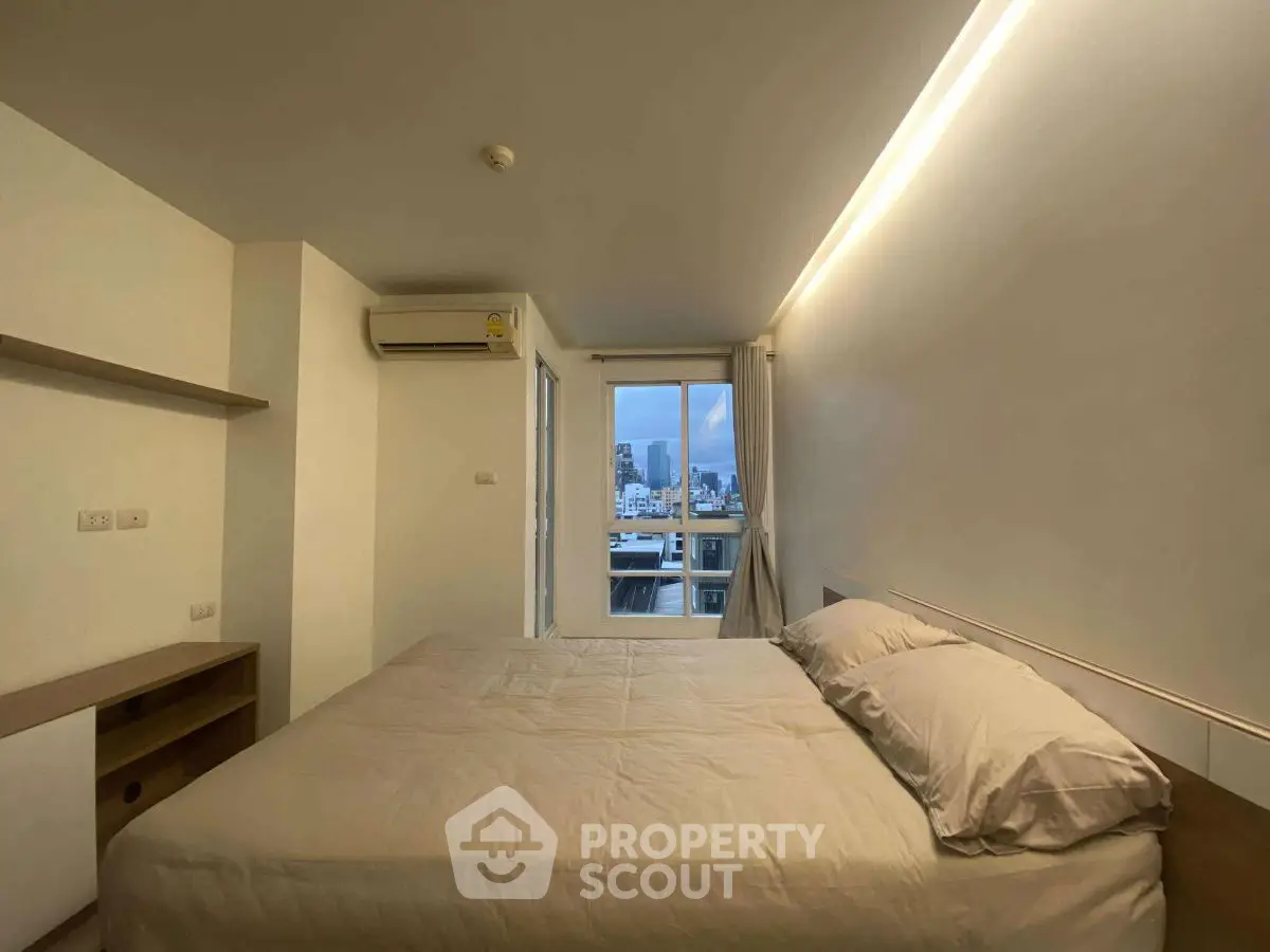 Modern bedroom with city view and ambient lighting