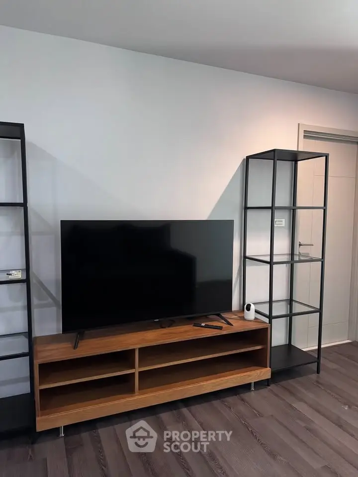 Modern living room with sleek TV stand and open shelving, perfect for stylish urban living.