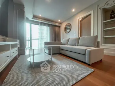 Modern living room with stylish furniture and large windows offering natural light.