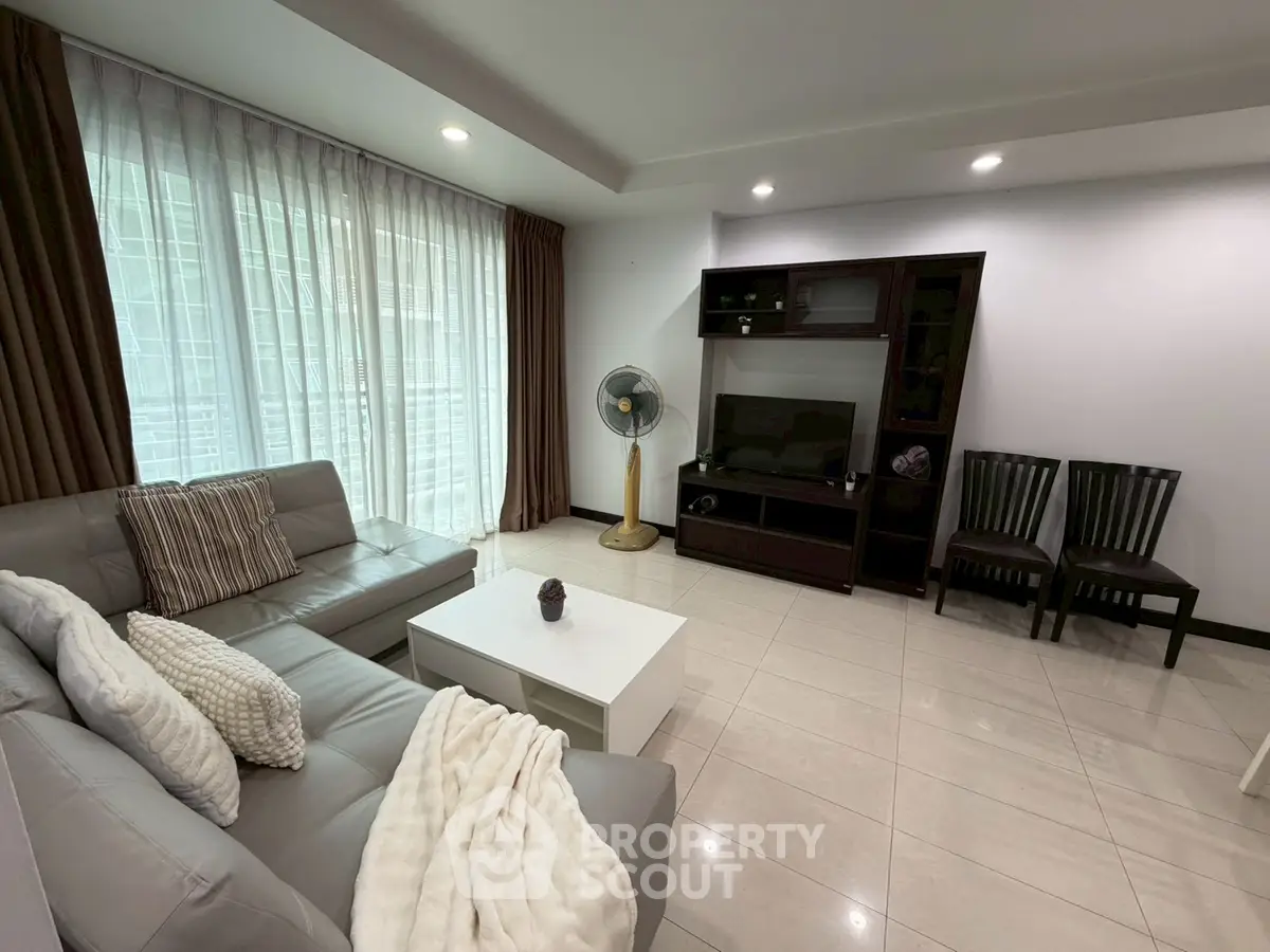 Spacious living room with modern decor and natural light