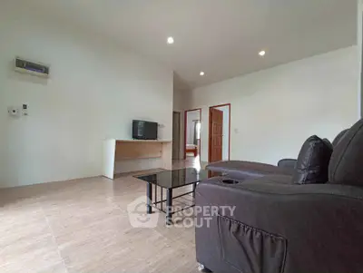 Spacious living room with modern furniture and sleek design.