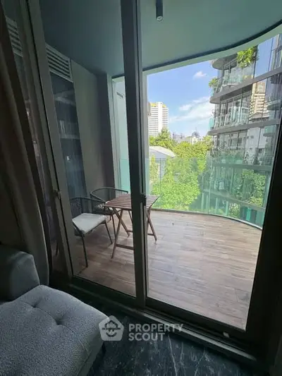 Chic urban balcony with modern furniture and city view, perfect for relaxation.