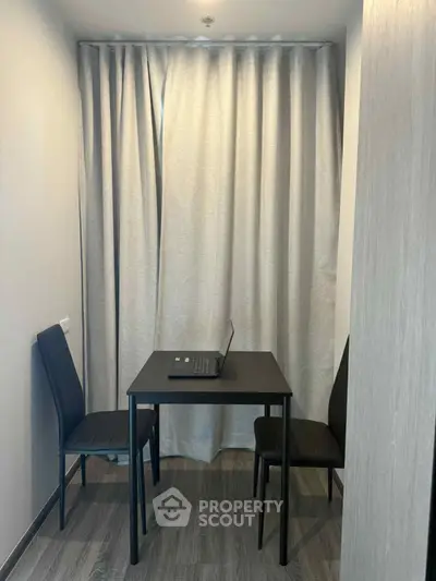 Cozy study nook with modern table and chairs, perfect for remote work or study sessions.