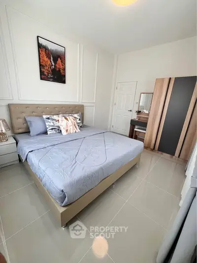 Modern bedroom with stylish decor and comfortable bed in a contemporary apartment.
