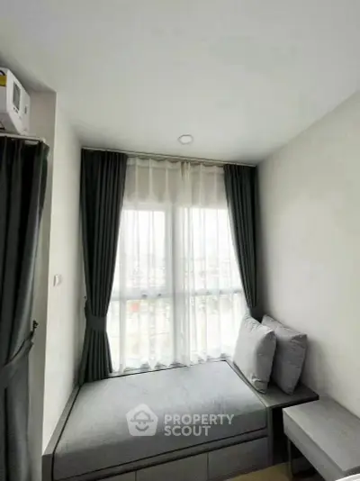 Cozy bedroom nook with large window and modern decor