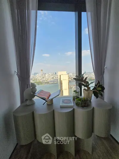 Stunning high-rise view from modern apartment with elegant decor and cityscape backdrop.