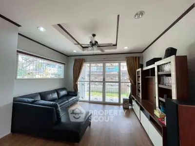 Spacious living room with modern decor and large windows offering natural light.