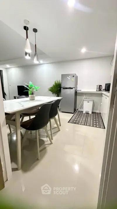 Modern kitchen and dining area with sleek appliances and stylish decor