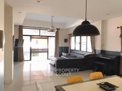 Spacious living room with modern decor and large windows for natural light.