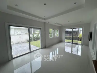 Spacious modern living room with large windows and glossy tile flooring