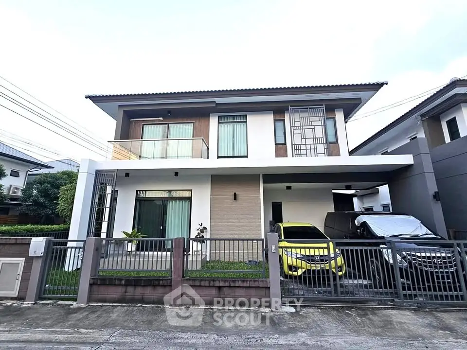 Modern two-story house with sleek design and spacious driveway