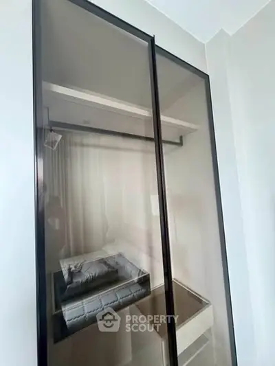 Modern glass wardrobe with sleek design and ample storage space