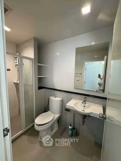 Modern bathroom with shower and sleek fixtures in contemporary apartment