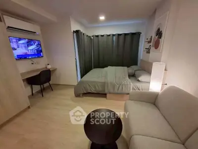 Modern studio apartment with cozy bedroom and living area, featuring sleek furniture and ambient lighting.