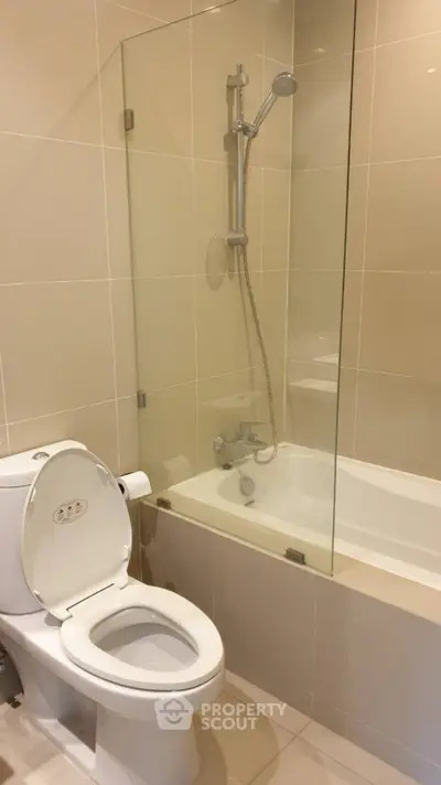 Modern bathroom with sleek design featuring a bathtub and shower combination.