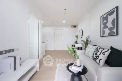 Modern living room with stylish decor and minimalist design, featuring a cozy white sofa and elegant artwork.