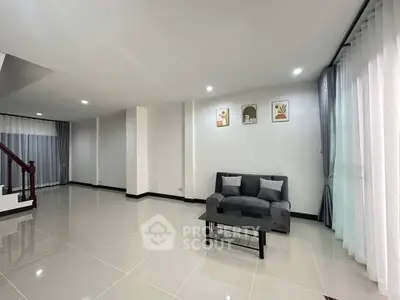 Spacious modern living room with sleek tile flooring and elegant decor