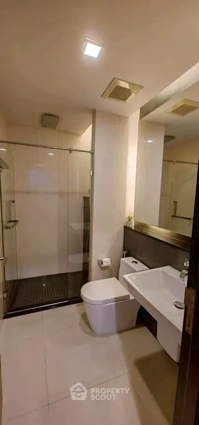 Modern bathroom with sleek fixtures and glass shower enclosure