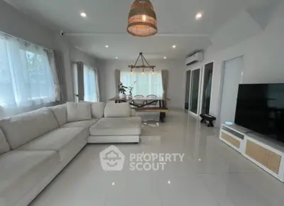 Spacious modern living room with elegant decor and large windows
