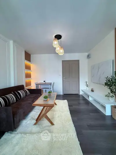 Modern living room with stylish decor, cozy sofa, and elegant lighting in a contemporary apartment.