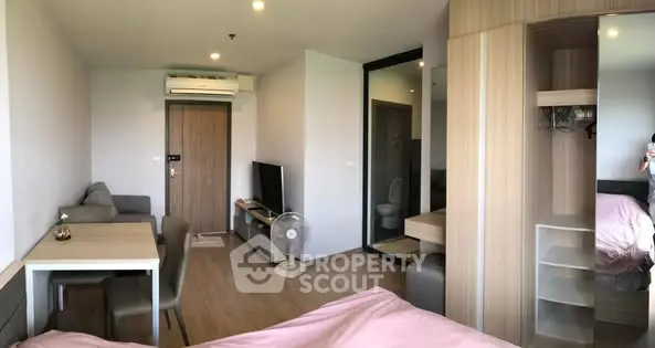 Modern studio apartment with cozy living area and stylish furniture