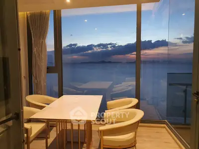 Stunning ocean view dining area with modern furniture and floor-to-ceiling windows.