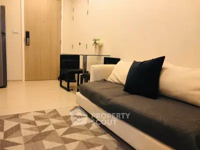 Cozy modern living room with stylish sofa and dining area, perfect for urban living.