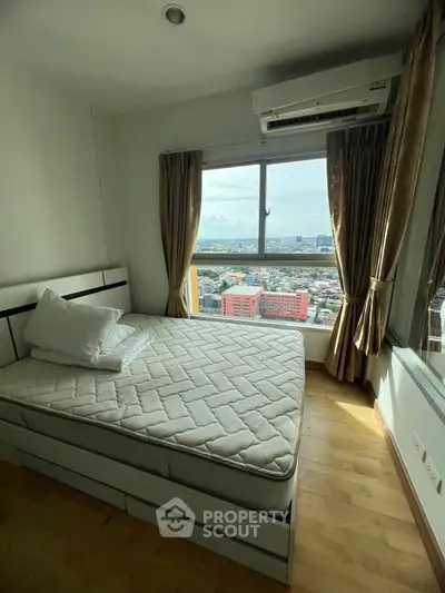 Cozy bedroom with large window offering stunning city views, featuring a comfortable bed and elegant curtains.