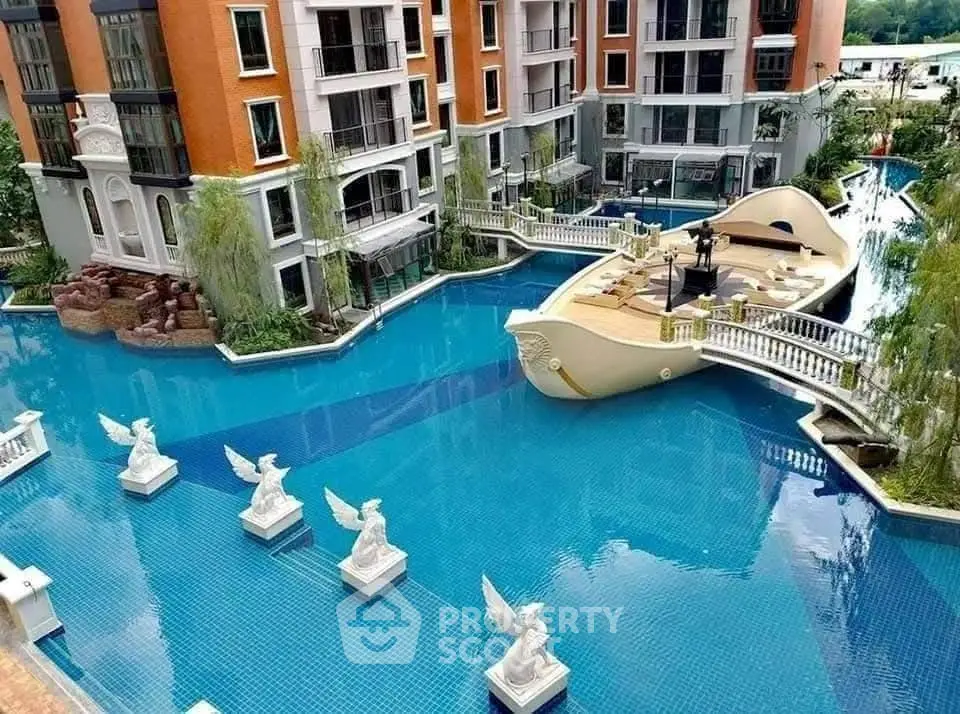 Luxurious apartment complex with unique boat-shaped pool and elegant statues.