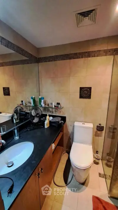 Modern bathroom with sleek fixtures and ample counter space in a stylish apartment.