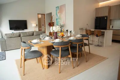 Modern open-plan living and dining area with stylish furniture and natural light.