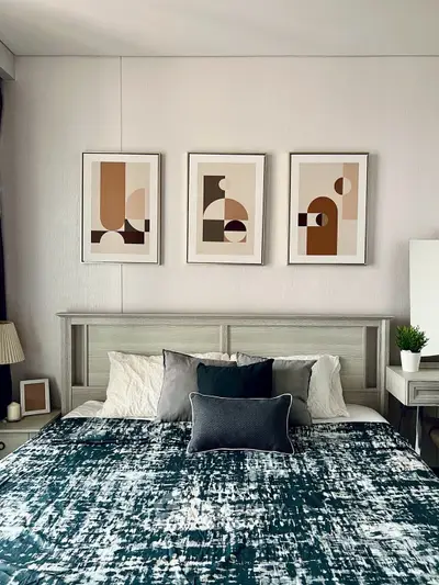 Modern bedroom with stylish decor and abstract art above the bed