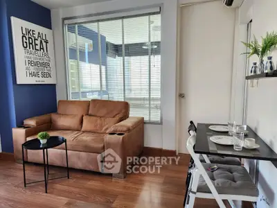 Modern living room with brown sofa, stylish decor, and dining area in a cozy apartment.