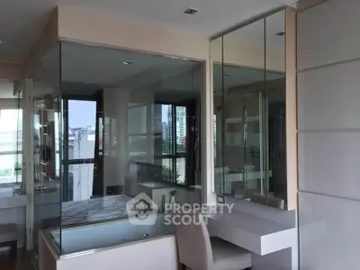 Luxurious bathroom with glass walls and city view, featuring a stylish vanity and modern design.