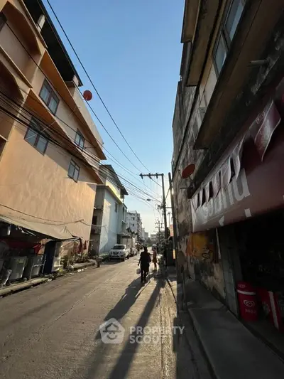 Urban street view with residential buildings and clear blue sky