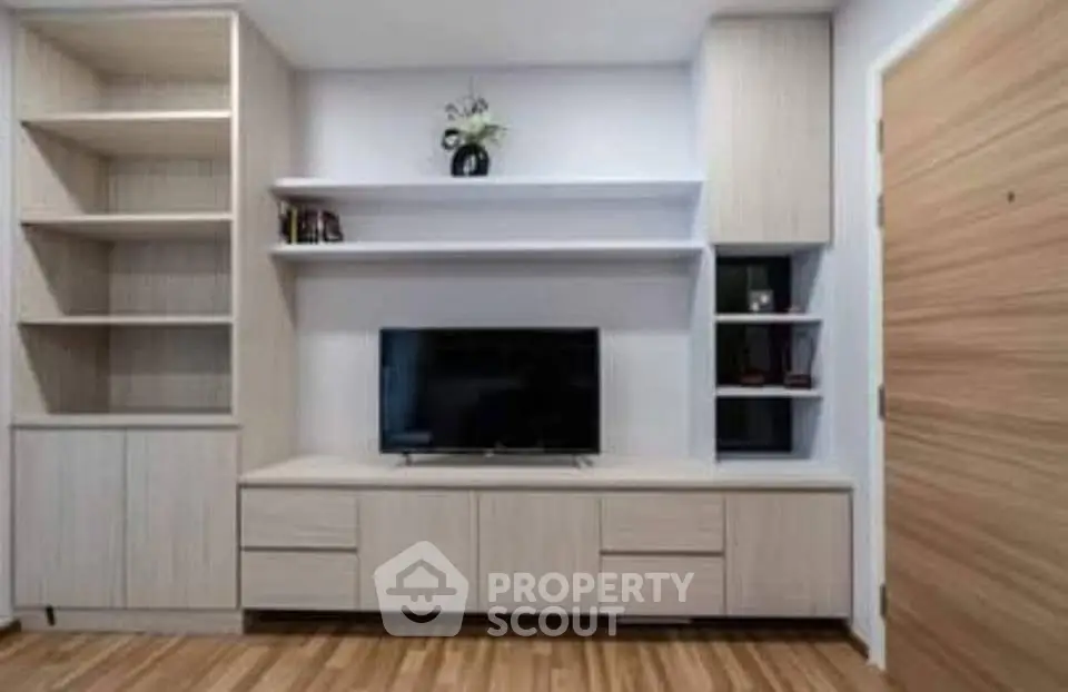 Modern living room with built-in shelves and sleek TV unit, perfect for stylish urban living.