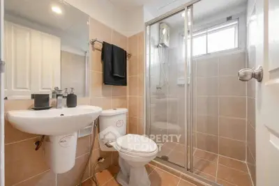Modern bathroom with glass shower and sleek fixtures in a stylish real estate property.