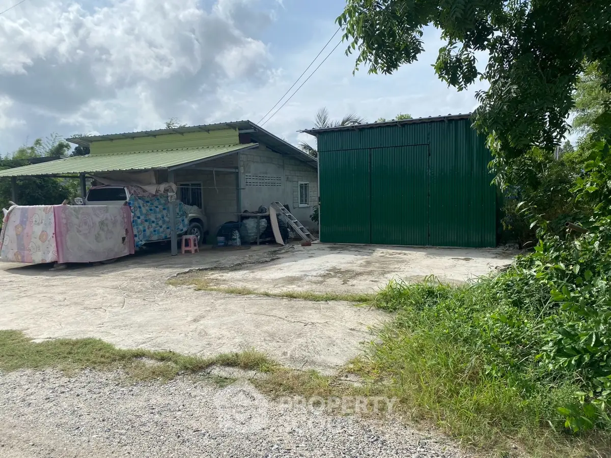 Charming rural property with spacious yard and green storage shed, perfect for countryside living.