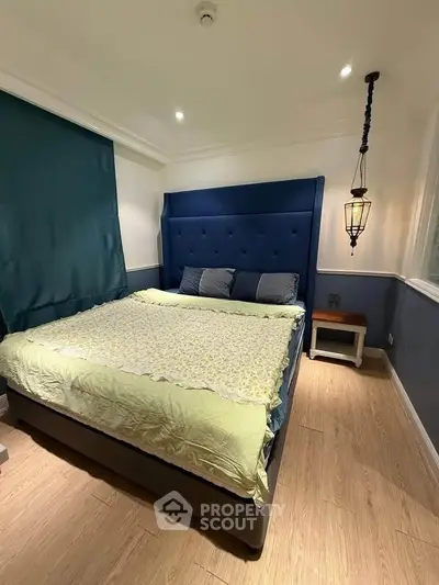 Luxurious bedroom with elegant blue headboard and cozy lighting