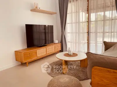 Stylish living room with modern TV setup and elegant wooden furniture