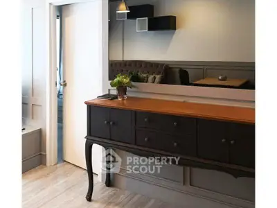 Stylish interior with elegant console table and modern decor in a cozy living space.