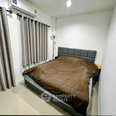 Cozy bedroom with modern bed and air conditioning, perfect for restful nights.
