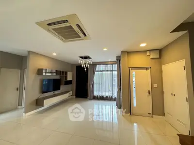 Spacious modern living room with sleek design and large windows for natural light.