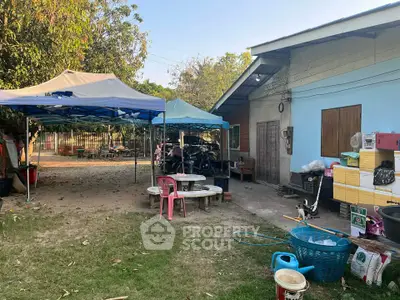 Charming rural property with outdoor seating and storage, ideal for relaxed living.
