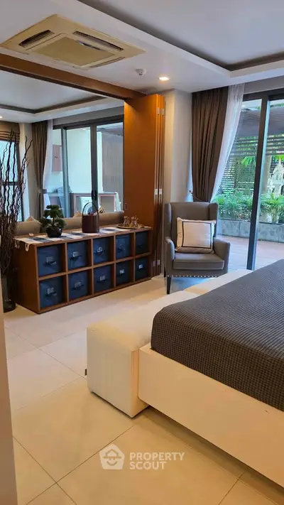 Luxurious bedroom with modern decor and garden view, featuring elegant furniture and large windows.